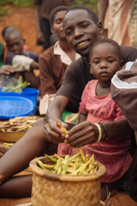 Malawian father shucking beans. Source: Mitchell Maher (IFPRI), 2016